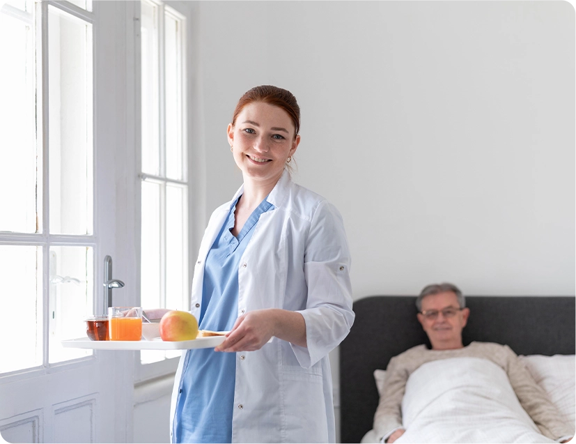 In-home caregiver serving a fresh, nutritious meal for a senior